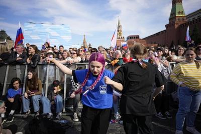 Putin uses public holiday to laud patriotic feelings as support for troops in Ukraine