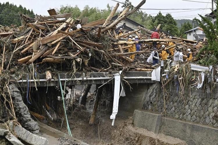 Rescue workers search for at least 6 people missing after heavy rain pounds Japan’s Noto region