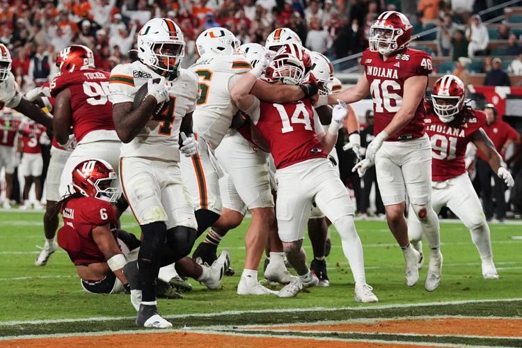 Indiana completes undefeated season and wins first national title, beating Miami 27-21 in CFP final