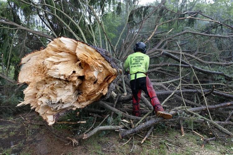 Rare New England tornado lifts car from a highway as strong storms damage homes and flood roads