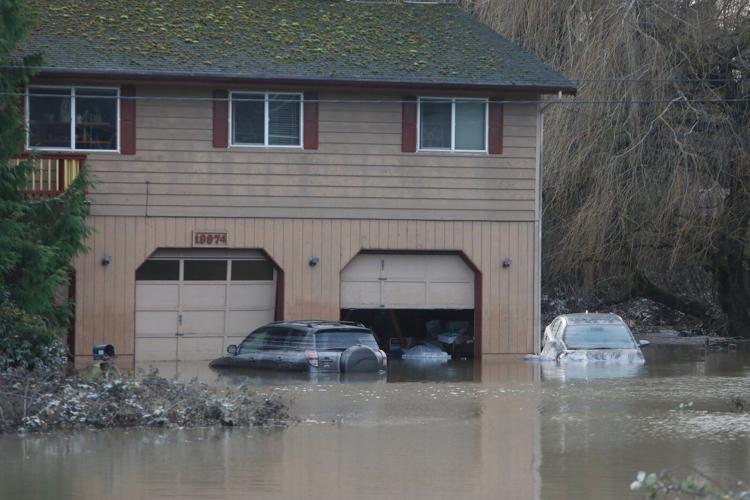 Arctic air sweeps south as residents of the Pacific Northwest remain on guard after severe flooding
