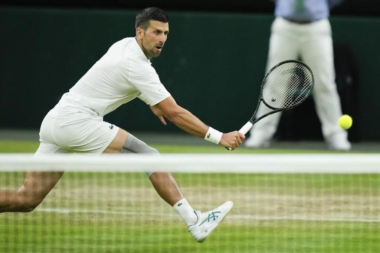 Novak Djokovic reaches a record 13th Wimbledon semifinal when an injured Alex de Minaur withdraws