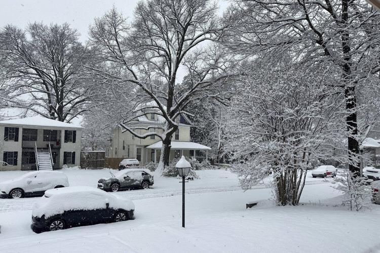 Powerful winter storm dumps heavy snow, causing flight delays, slick roads and school closings