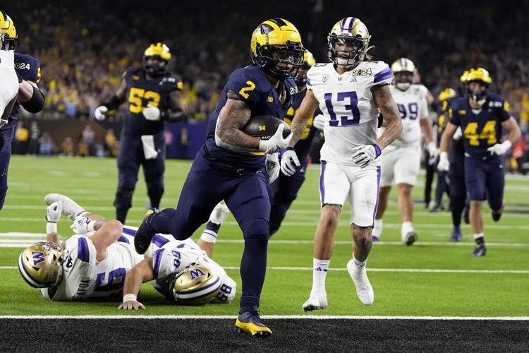 Jim Harbaugh delivers a national title. Corum scores 2 TDs, Michigan overpowers Washington 34-13