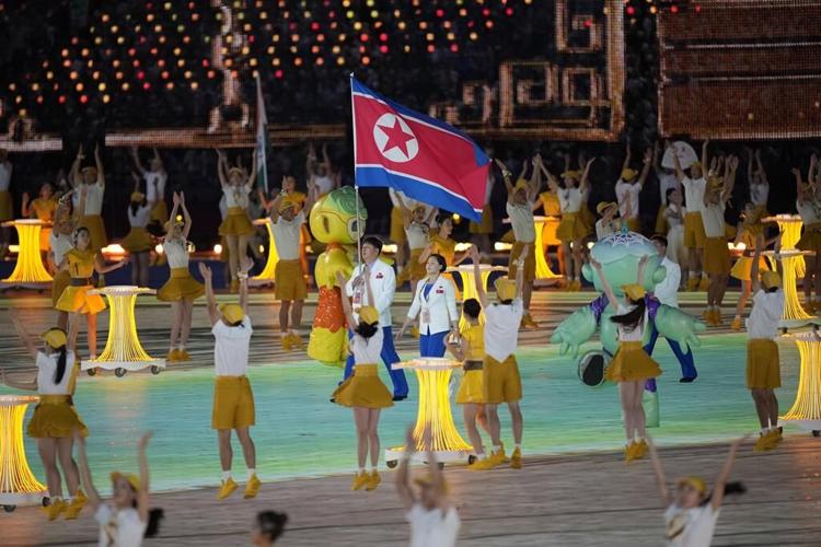 Lots of dignitaries but no real fireworks - only electronic flash - as the Asian Games open