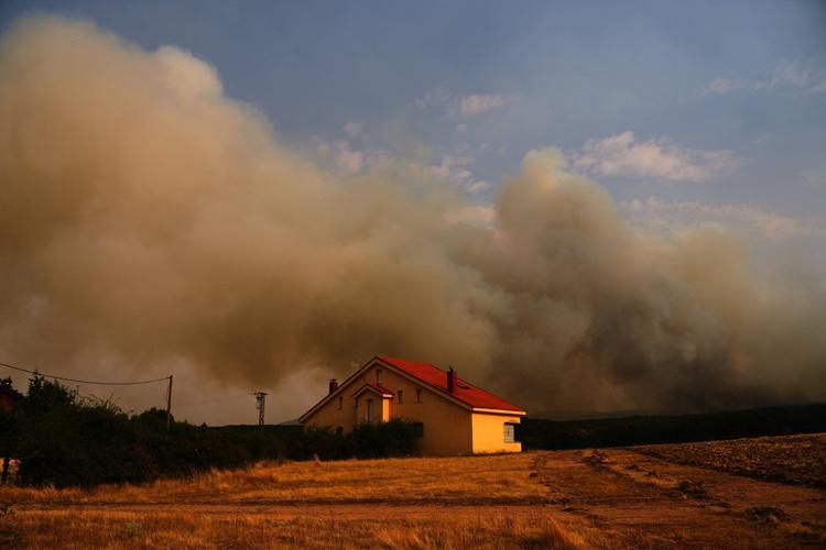 Firefighters battle one of Spain's biggest-ever wildfires during heat wave across the Mediterranean
