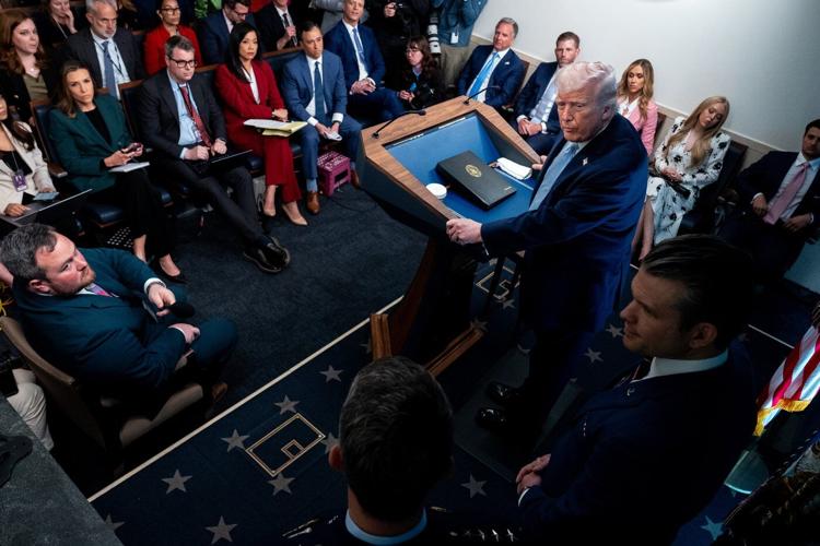 Photos of Trump's Monday, talking Iran at Easter Egg Roll and mimicking a sniper in the press room