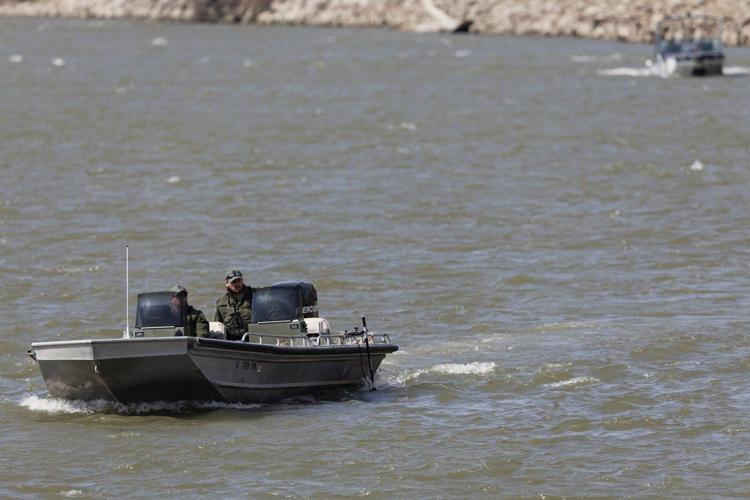 Nebraska officials search the Missouri River near Omaha for two teens and a child