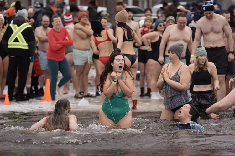 Many mark the new year with 'exhilarating' polar dip in icy water