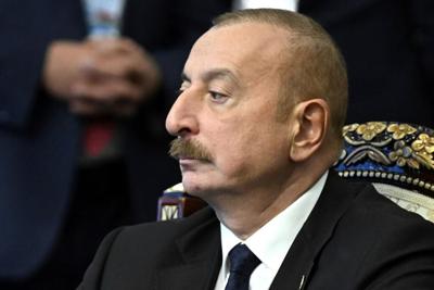 Azerbaijan's president raises the nation's flag in a former breakaway region's capital