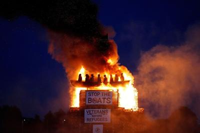 Burning of migrant boat effigy in Northern Ireland triggers police investigation