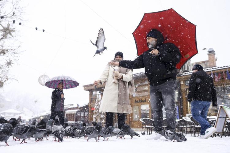 Rescuers reach a stranded hiker in Slovenia but another is missing during a Balkans snowstorm