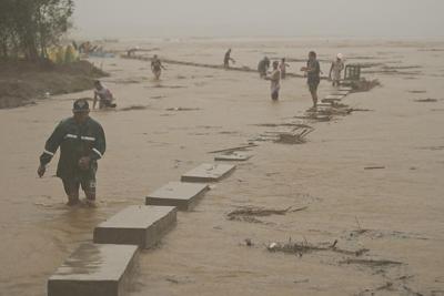 Typhoon batters storm-weary Philippines and displaces thousands more people as a new storm threatens