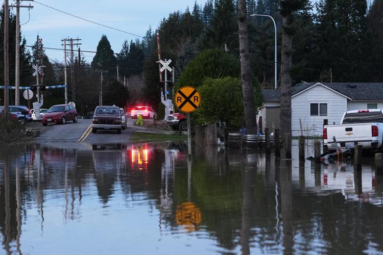 Arctic air sweeps south as residents of the Pacific Northwest remain on guard after severe flooding