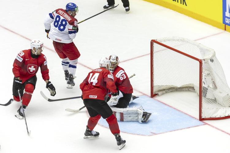 Czechs open their defense of hockey worlds title with 5-4 win over Switzerland