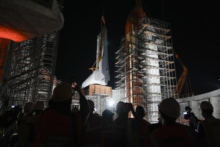 Space shuttle Endeavour hoisted for display in launch configuration at Los Angeles science museum