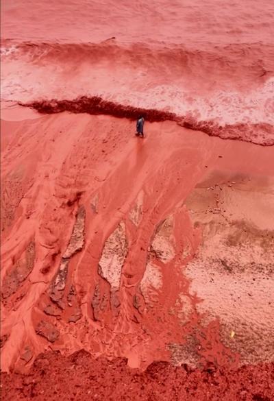 Rain creates a crimson spectacle on Iran's Hormuz Island for the first time this year