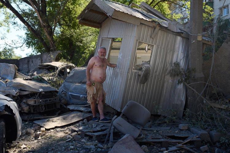Photos show Kyiv residents clutching pets, collecting bodies after Russian missile and drone attack