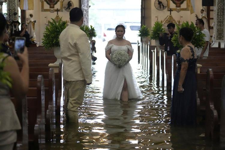 Photos show a Filipino couple walking down a flooded aisle on their wedding day