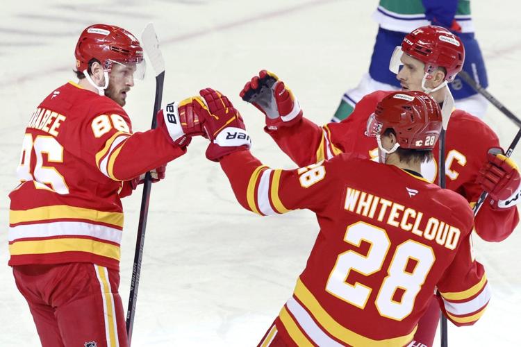 Flames ignite their offence, burn Canucks 7-3