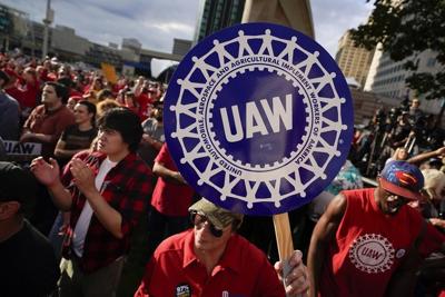 GM says strike cost $1.1B, but it can absorb rising labor costs as it raises dividend