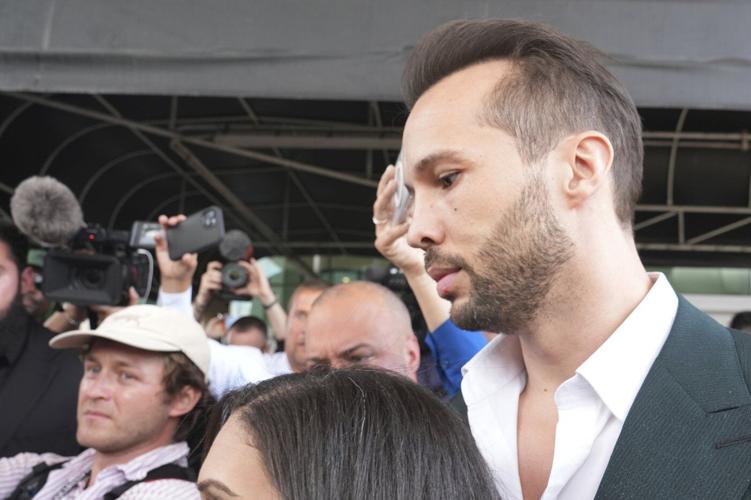 Influencer Tate brothers, who face human trafficking charges in Romania, arrive in the US