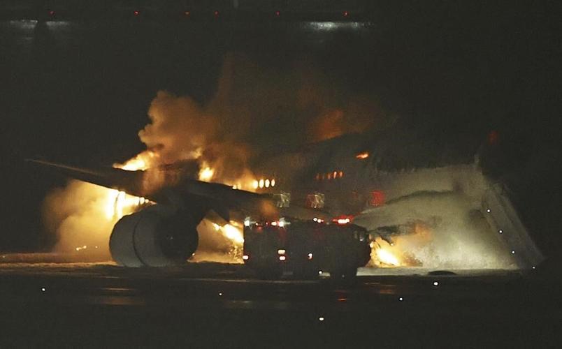 Plane catches fire on runway at Japan's Haneda airport after collision, passengers reportedly safe