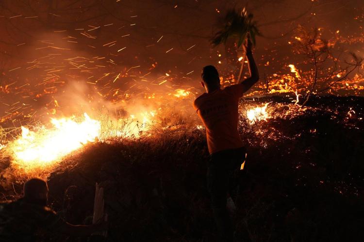 Firefighters battle a wildfire burning out of control on the Greek island of Chios