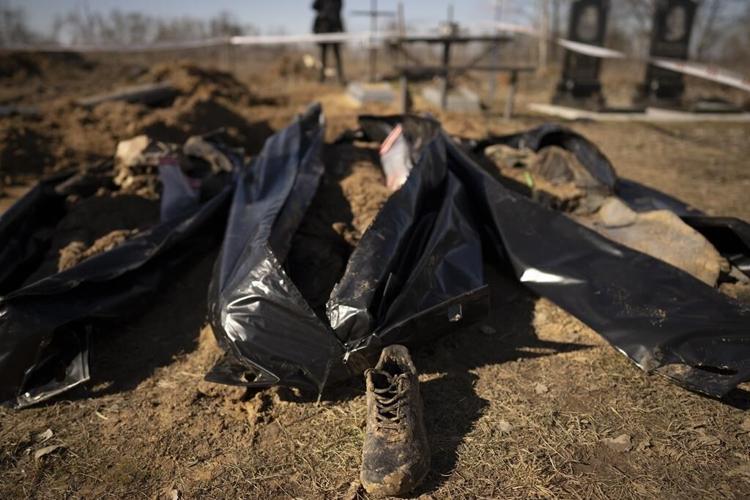 A year into Ukraine war, bodies dug up in once occupied town