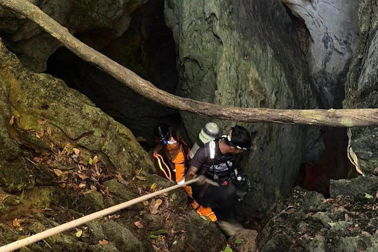 Rescuers search for alternative route to reach 2 missing in a flooded Laos cave