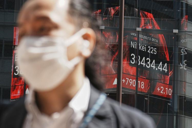 Asian shares gain after Wall Street's rally, but hopes are tempered by trade war uncertainties