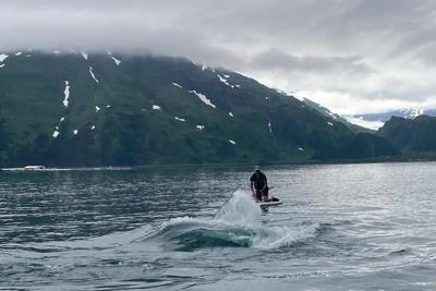 See how an Alaska paddleboarder escaped a close encounter with a humpback whale