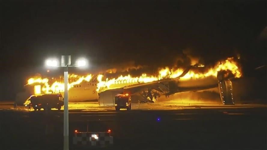 Plane catches fire on runway at Japan's Haneda airport after collision, passengers reportedly safe