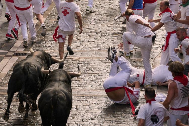 Daredevils run with charging bulls at Pamplona's famous San Fermín festival