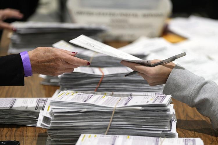 Justice Department's early moves on voting and elections signal a shift from its traditional role