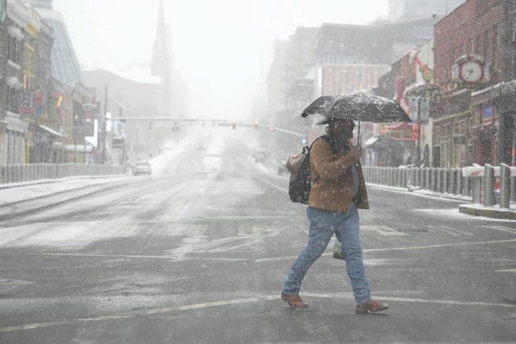 Powerful winter storm dumps heavy snow, causing flight delays, slick roads and school closings