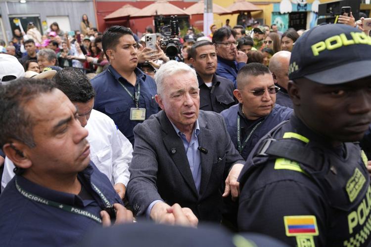 Colombian ex-leader known for contentious war on rebels pays tribute to slain presidential hopeful