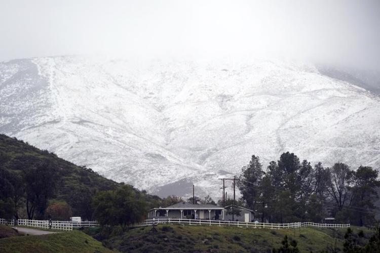Snow, rain slam California as Michigan suffers without power