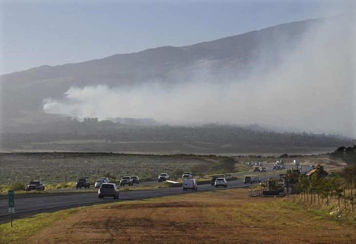 Hawaii wildfires burn homes and force evacuations, while strong winds complicate the fight