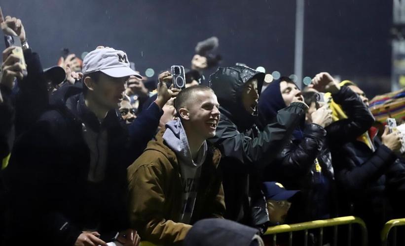 Michigan Wolverines return home to screaming fans after victory over Washington Huskies