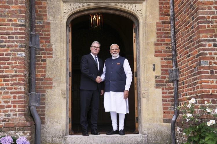 Photos of Britain's Starmer and India's Modi sealing a major trade agreement