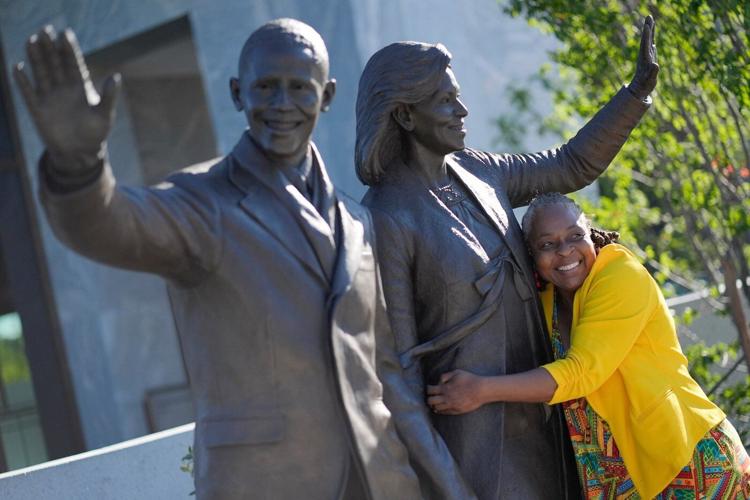 Barack and Michelle Obama surprise first visitors to newly opened presidential center