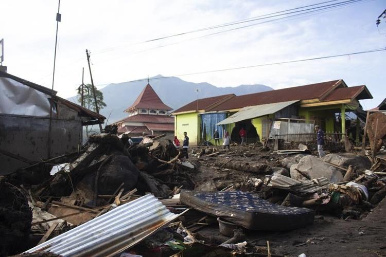Indonesian rescuers search through rivers and rubble after flash floods that killed at least 52