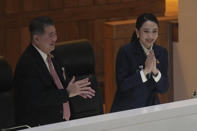 Thai prime minister survives a challenge by rivals who say her father is pulling the strings