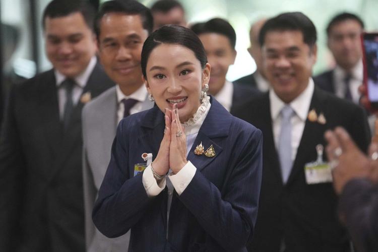 Thai prime minister survives a challenge by rivals who say her father is pulling the strings
