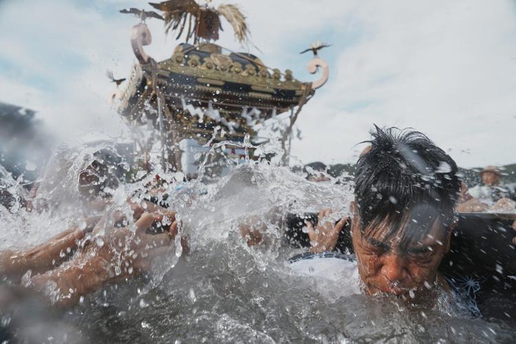 Photos show a town praying for marine safety at a seaside festival near Tokyo