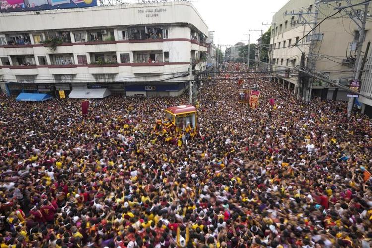 Filipino Catholics pray for Mideast peace in massive procession venerating a black statue of Jesus