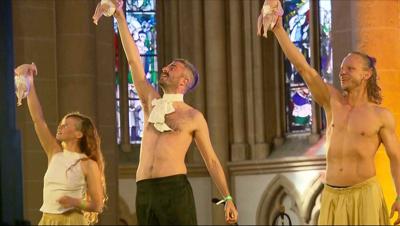 A show inside a cathedral featured raw chickens in diapers. The German president was in the audience