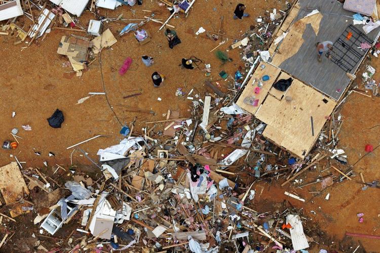 Survivors of Mississippi tornadoes crawled under furniture and held onto their kids