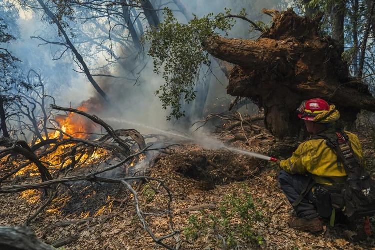Firefighters get some help from cooler temperatures after California's largest wildfire explodes